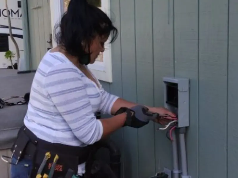 Licensed electrician wiring an exterior subpanel in Bridgeview